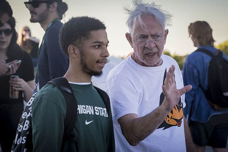 Advertising professor, Henry Brimmer discussing advertising with a student.