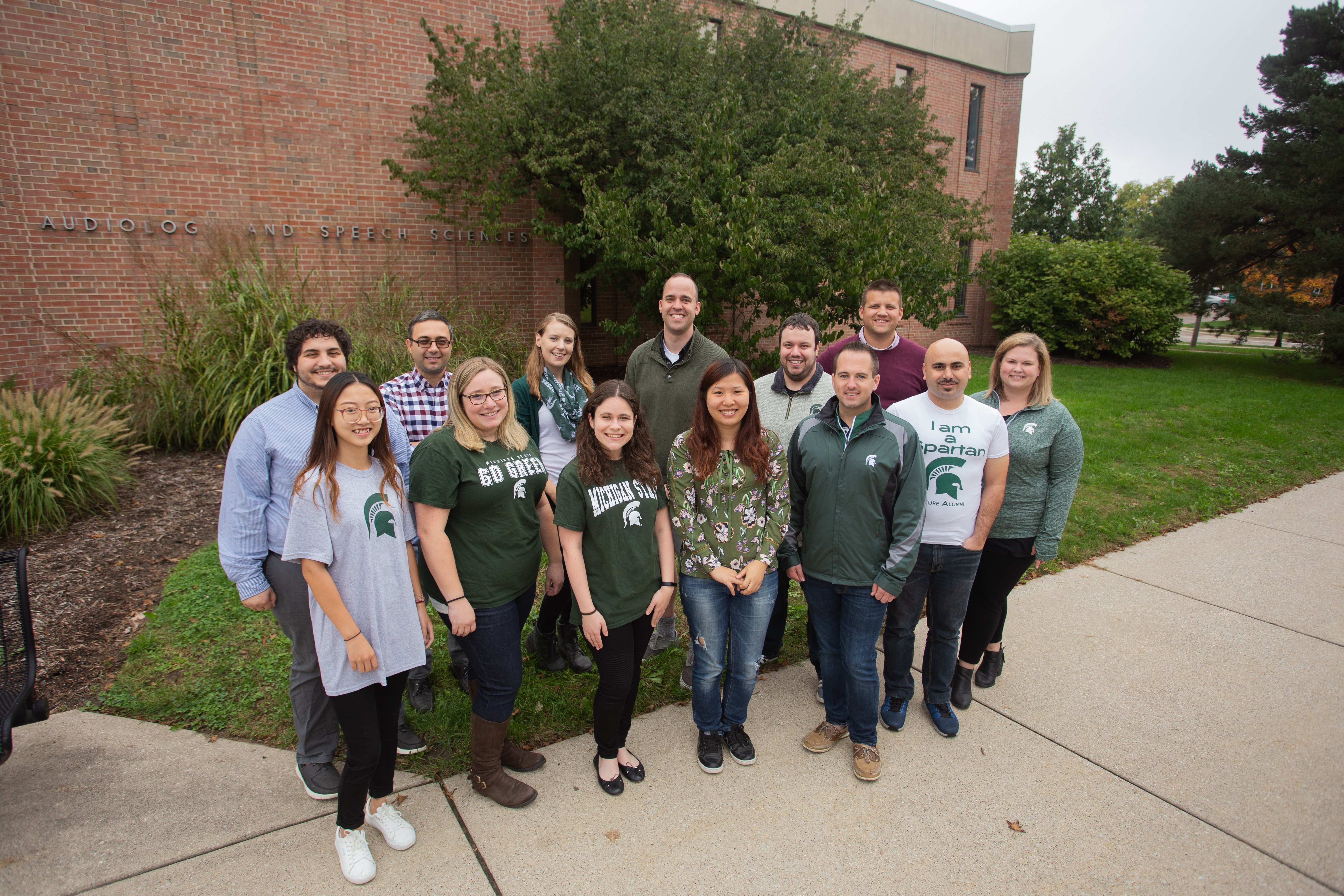 Several CSD Ph.D. students standing in front of the Oyer Building