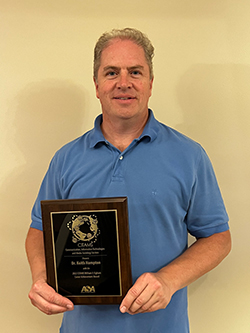 Keith Hampton holding his William F. Ogburn Career Achievement Award